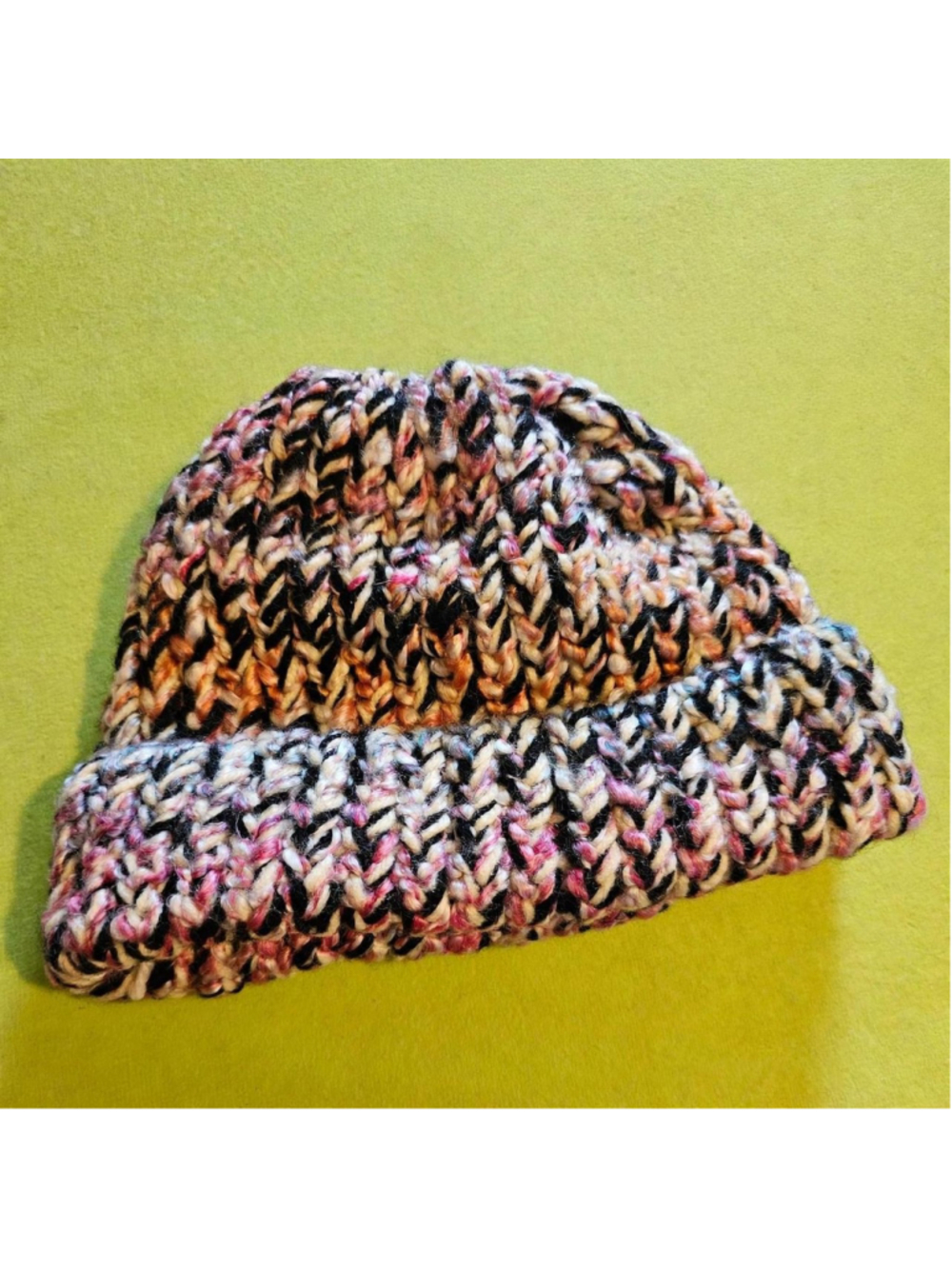Multi-colored knit beanie with black, pink, and beige yarn #winteraccessories #k